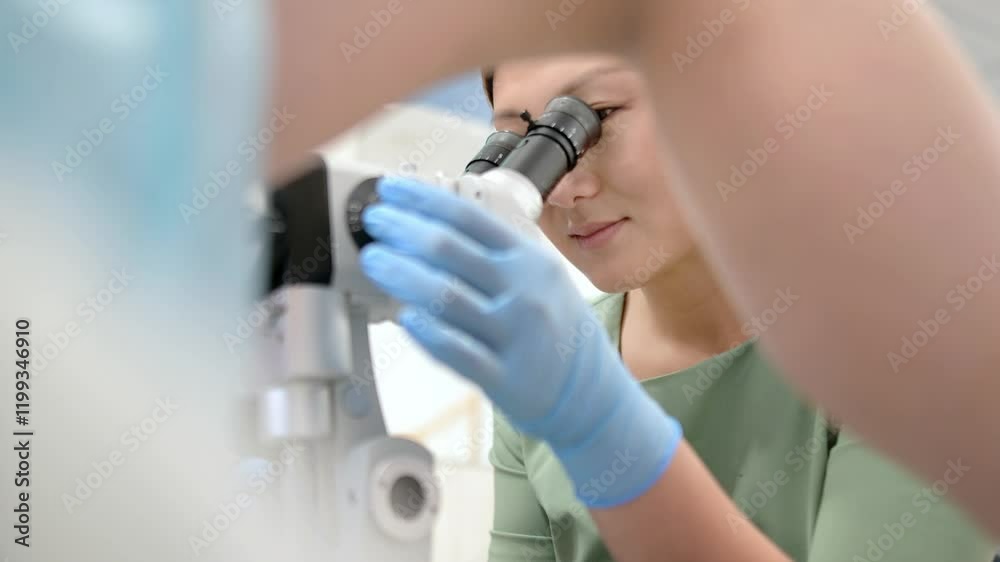 Gynecologist examines a patient using microscope in a gynecological chair. Doctor performs a colposcopy on a young girl in a modern medical office. Prevention and diagnosis of cervical cancer.