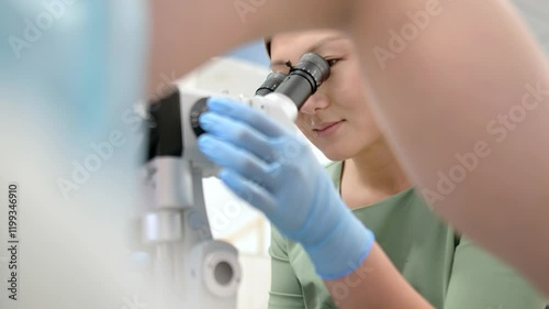Gynecologist examines a patient using microscope in a gynecological chair. Doctor performs a colposcopy on a young girl in a modern medical office. Prevention and diagnosis of cervical cancer.