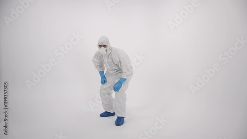 A scientist in PPE coming closer on a white background