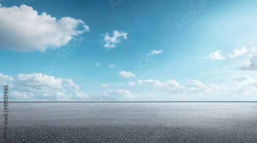 Vast Open Landscape with Smooth Horizon Under Bright Blue Sky and Fluffy White Clouds, Suitable for Text Overlay or Design Elements photo