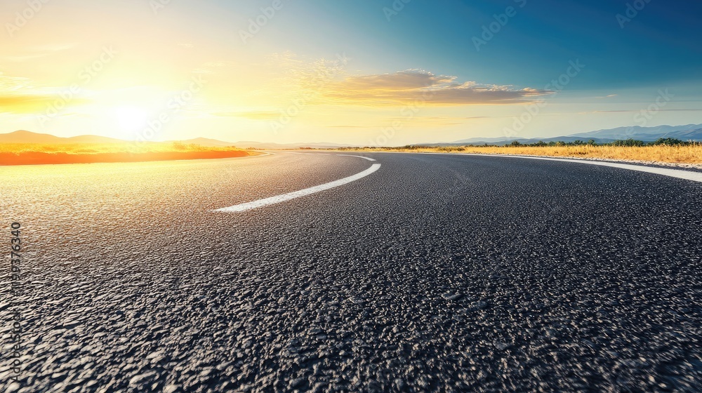 Fototapeta premium Desert highway at sunset with clear blue sky and empty space for text usage