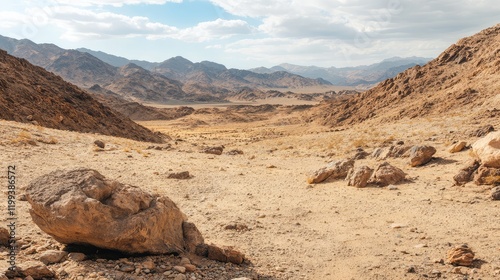 Desert Landscape Featuring Brown Rocks and Mountains Under Blue Sky with Ample Copy Space for Text in Arid Environment