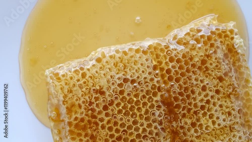 honey flowing over natural honeycomb
