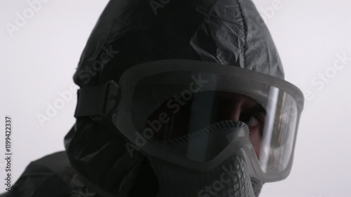 Scientist in PPE backs off on white background