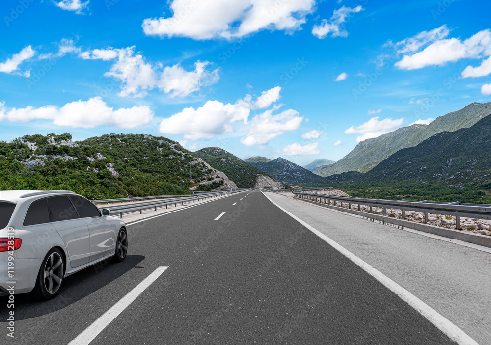 Car is driving along the highway surrounded by picturesque nature.