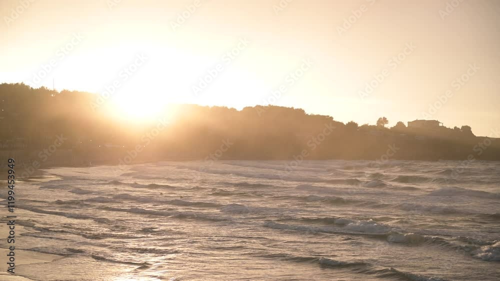 baia del gargano al tramonto con un antico trabucco in lontananza baia del gargano al tramonto con un antico trabucco in lontananza