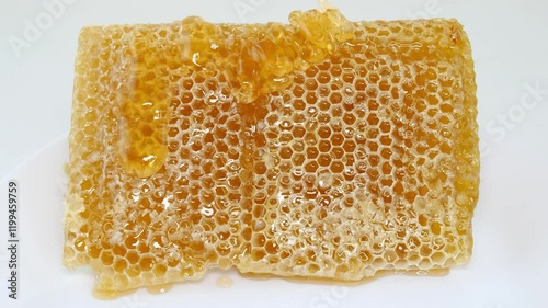 honey flowing over natural honeycomb