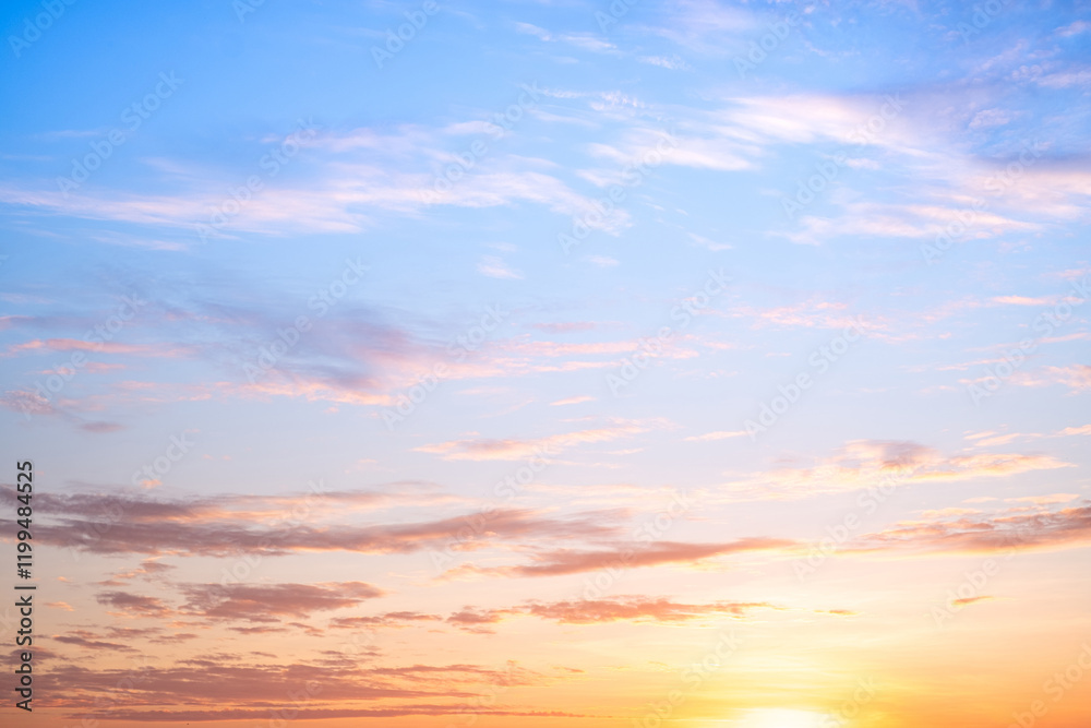 Fototapeta premium Sky,sunset, beautiful , luxury soft gradient orange gold clouds and sunlight on the blue sky perfect for the background, Sunrise on morning or everning in winter warm time ,Twilight summer,silhouette