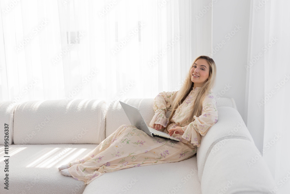 beautiful young happy woman with laptop on sofa beautiful young happy woman with laptop on sofa