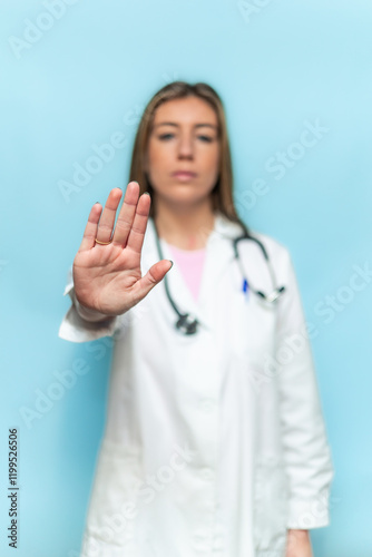 Obraz na płótnie vertical Serious female doctor making stop sign with hand, medical advice and he