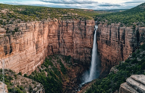 Photo of a waterfall cascading down a cliff in a mountainous area