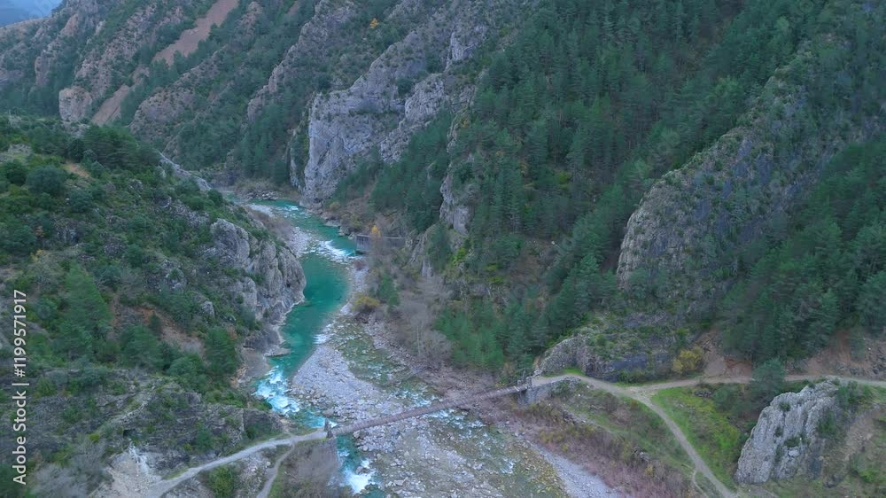 Surroundings of the village of Janovas. Winter landscape and aerial view from a drone of the village, the Ara river and the Congosto de Janovas. Sobrarbe region. Huesca. Aragon. Spain. Europe. Surroundings of the village of Janovas. Winter landscape and aerial view from a drone of the village, the Ara river and the Congosto de Janovas. Sobrarbe region. Huesca. Aragon. Spain. Europe.