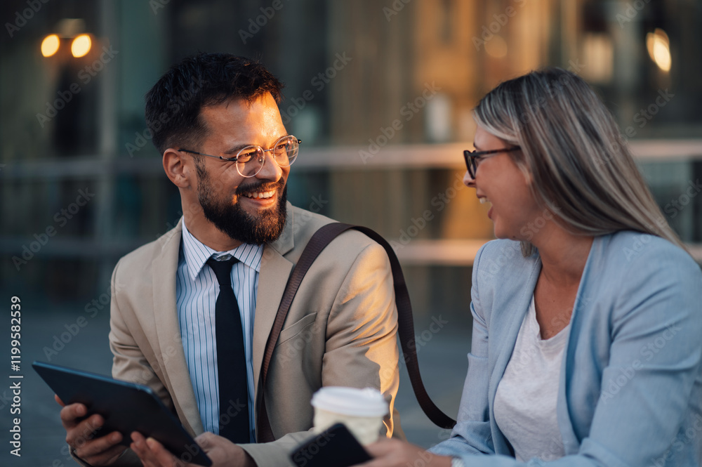 Fototapeta premium Business people having fun using digital tablet outdoors after work
