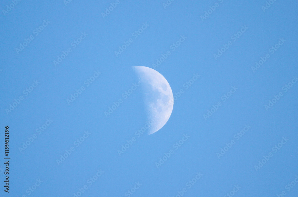 A beautiful crescent moon shines brightly in a clear blue sky A beautiful crescent moon shines brightly in a clear blue sky