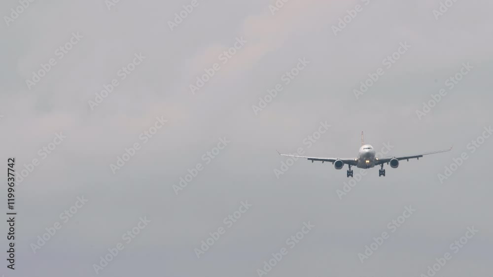 Aircraft approaching to land, long shot, front view. Commercial airliner descending. Tourism and travel concept Aircraft approaching to land, long shot, front view. Commercial airliner descending. Tourism and travel concept