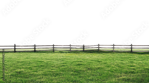 Lush green grass field with a rustic wooden fence against a dark background, perfect for nature-themed projects.