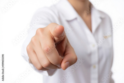 a close-up of a person wearing a white lab coat, pointing their index finger directly at the camera. The background is blurred and white