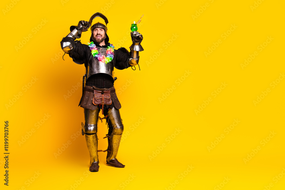 Young man dressed as a medieval knight on a vibrant yellow background holding a party drink. Young man dressed as a medieval knight on a vibrant yellow background holding a party drink.