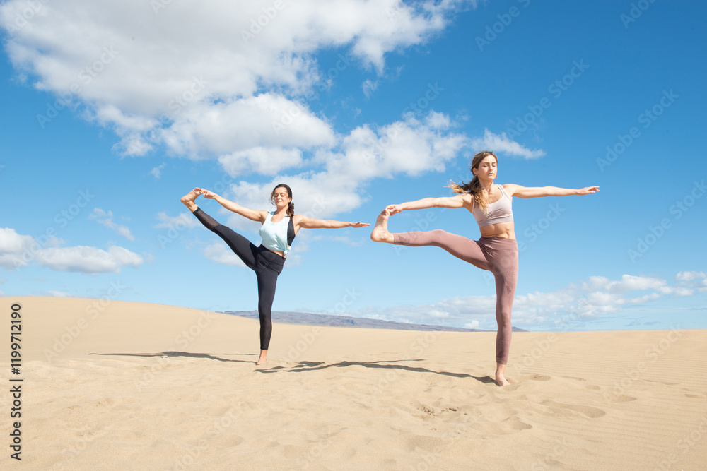 women doing yoga and stretching exercises on the beach women doing yoga and stretching exercises on the beach