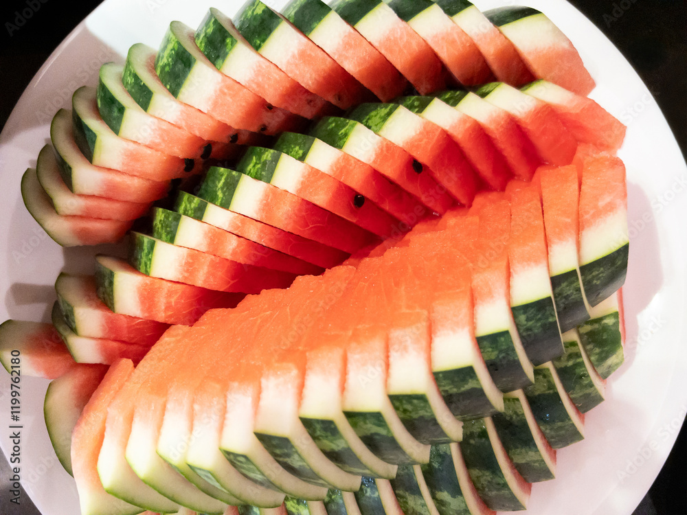 Beautifully arranged watermelon slices on a plate.