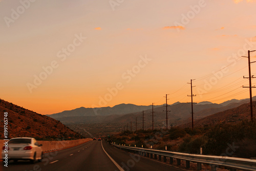 Driving on the road at sunset in Palm Springs, California.