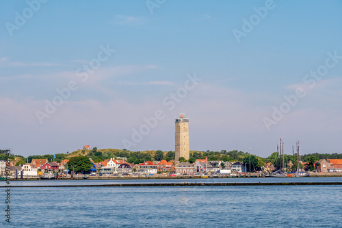 Skyline of West-Terschelling harbor and Brandaris lighthouse on West Frisian island Terschelling from Waddensea, Friesland, Netherlands photo