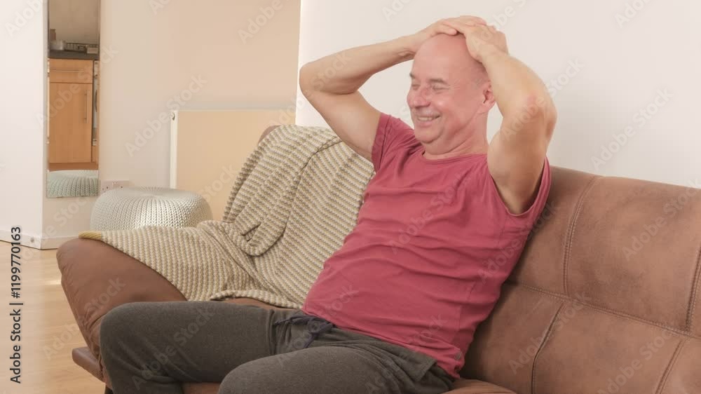 Cheerful Joyful senior man smiles on sofa, happy with SeniorLife, capturing joyful moment, self-development, emotional wellnes, aging gracefully Cheerful Joyful senior man smiles on sofa, happy with SeniorLife, capturing joyful moment, self-development, emotional wellnes, aging gracefully
