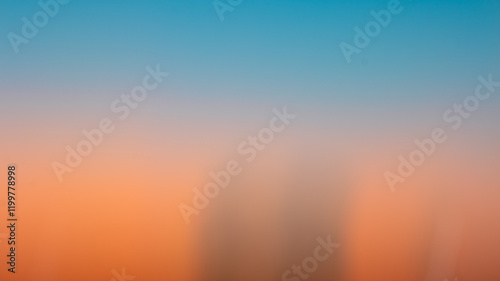 The image showcases the beauty of intentional camera movement (ICM) photography, blending vivid orange and deep blue hues of a sunset with streaks of light creating an abstract, dreamlike effect.