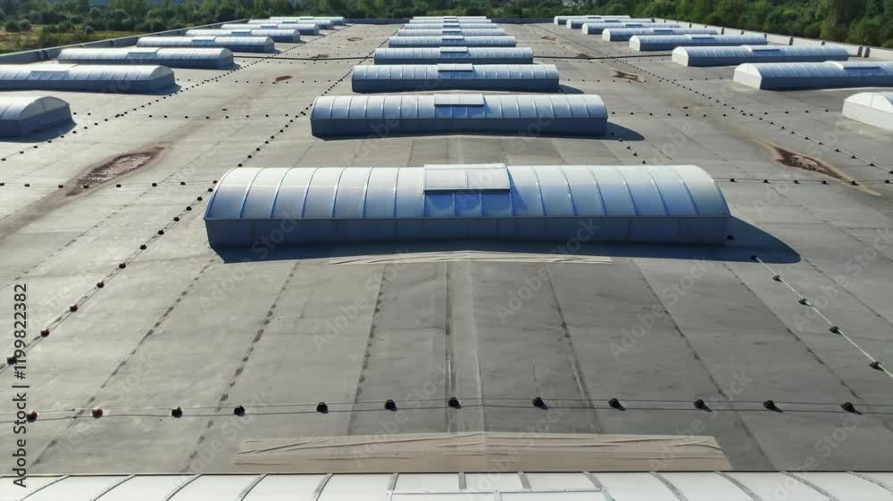 Drone shooting of rooftop of modern logistics hub. Exterior of distribution center. Contemporary industrial factory building. Commercial property concept. Aerial perspective. Metal construction Drone shooting of rooftop of modern logistics hub. Exterior of distribution center. Contemporary industrial factory building. Commercial property concept. Aerial perspective. Metal construction