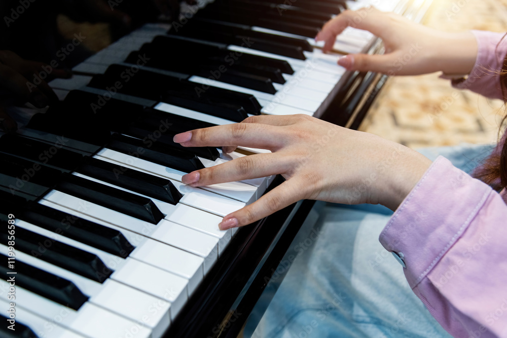 Obraz premium Close up of woman hands playing piano