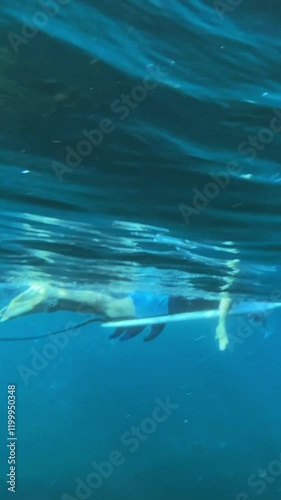 Wallpaper Mural Male surfer sitting on a surfboard in Indian Ocean and waiting his wave. Vertical video Torontodigital.ca
