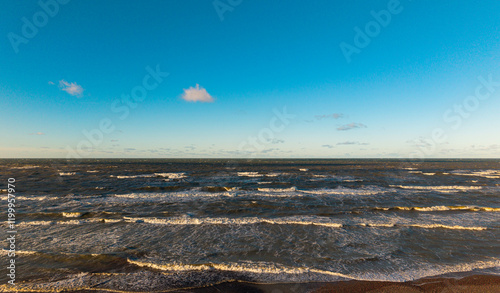 Sea in sunny weather with blue sky. Waves. Sea background
