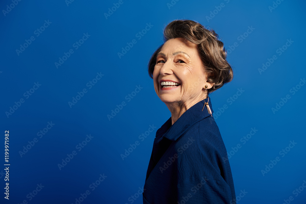 A radiant woman in her 60s showcases style and grace with a joyful smile. A radiant woman in her 60s showcases style and grace with a joyful smile.