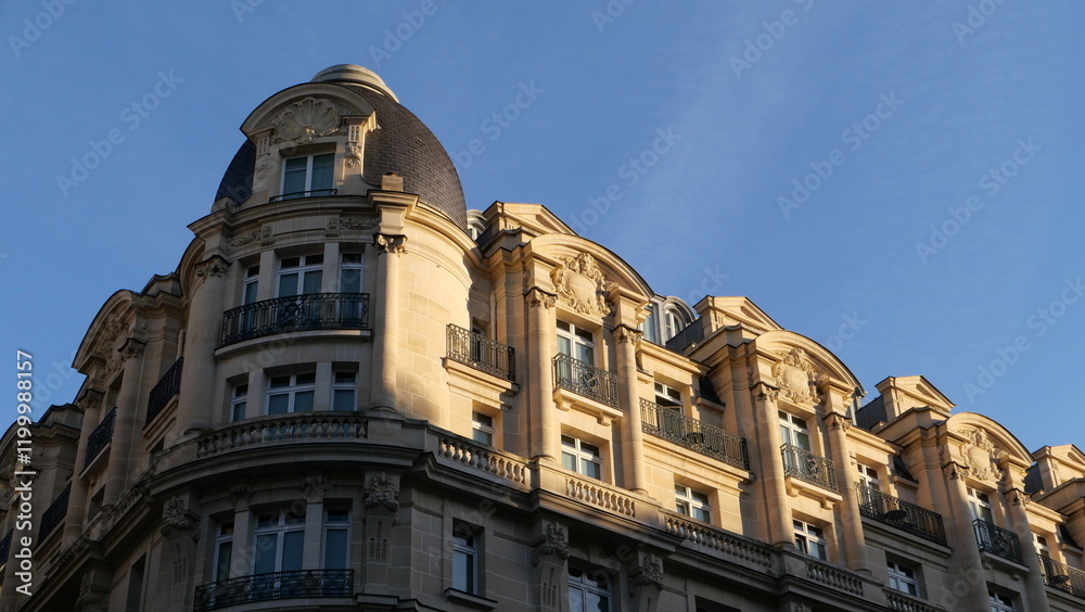 Elegant historic Paris building with intricate architecture under a clear blue sky in a cityscape. Elegant historic Paris building with intricate architecture under a clear blue sky in a cityscape.