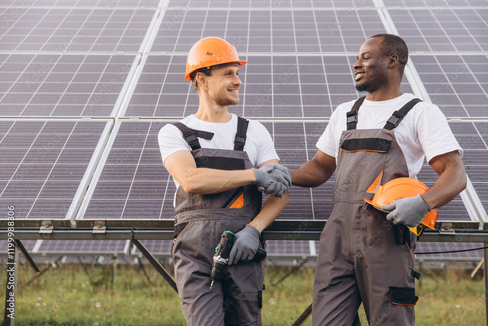 Two Engineers Shaking Hands in Front of Solar Panels Two Engineers Shaking Hands in Front of Solar Panels