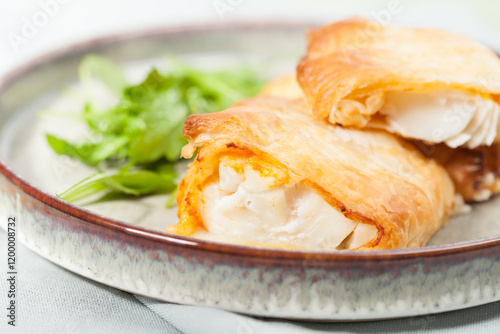 Baked cod fillet in puff pastry with red pesto.