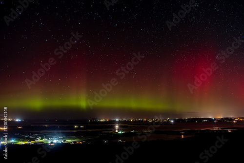 The Aurora Borealis, the northern lights, showing up above Maghery, Burtonport, Arranmore and Dungloe in County Donegal, Ireland. photo