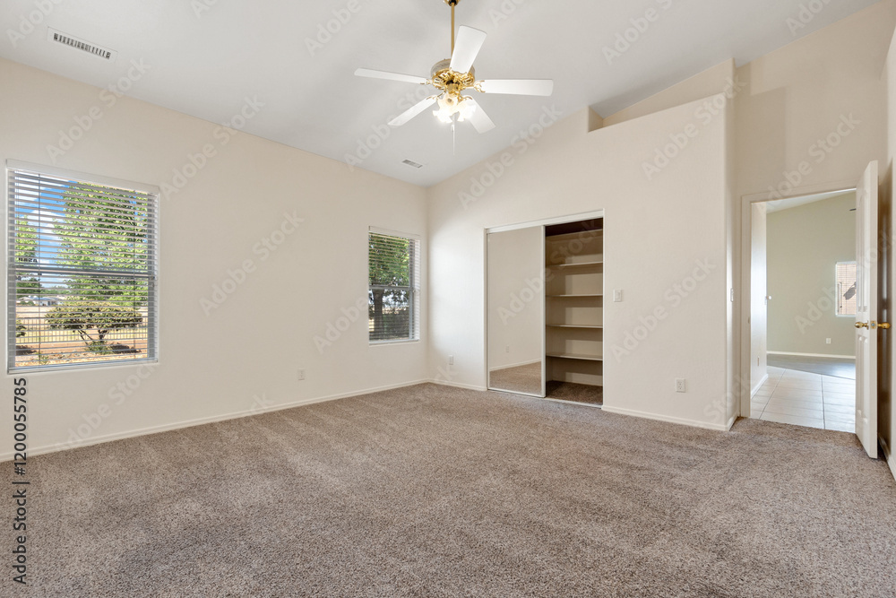 Fototapeta premium Spacious living room with wooden flooring and sliding doors leading to a bright outdoor area