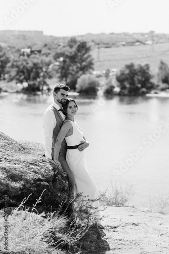 Obraz na płótnie bride blonde girl and groom near the river w salonie