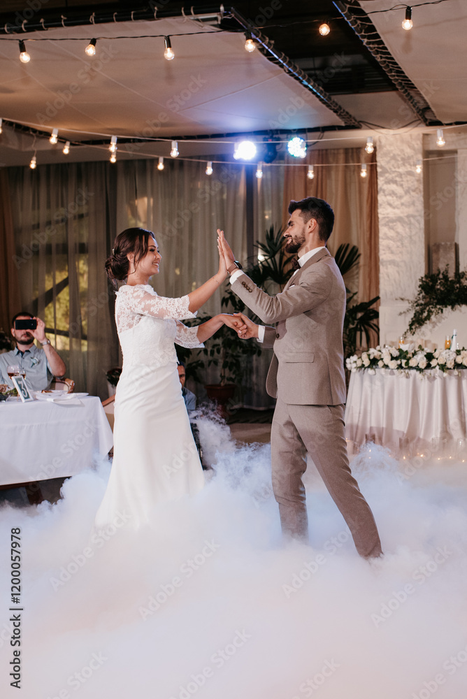 the first dance of the bride and groom inside a restaurant