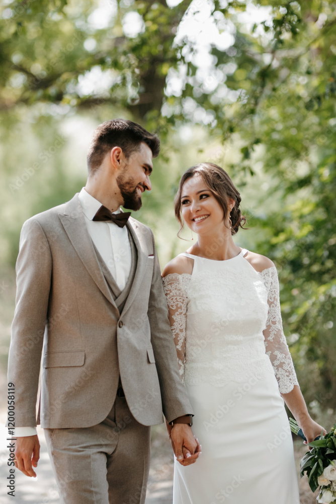 guy and a girl newlyweds are walking in the forest