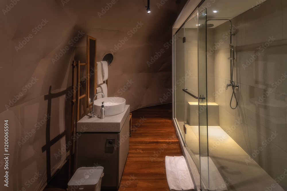 This modern bathroom features a stunning glass shower, elegant sinks, and warm wood accents, creating a calming atmosphere for relaxation after a long day