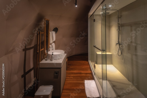 Obraz na płótnie This modern bathroom features a stunning glass shower, elegant sinks, and warm wood accents, creating a calming atmosphere for relaxation after a long day w salonie