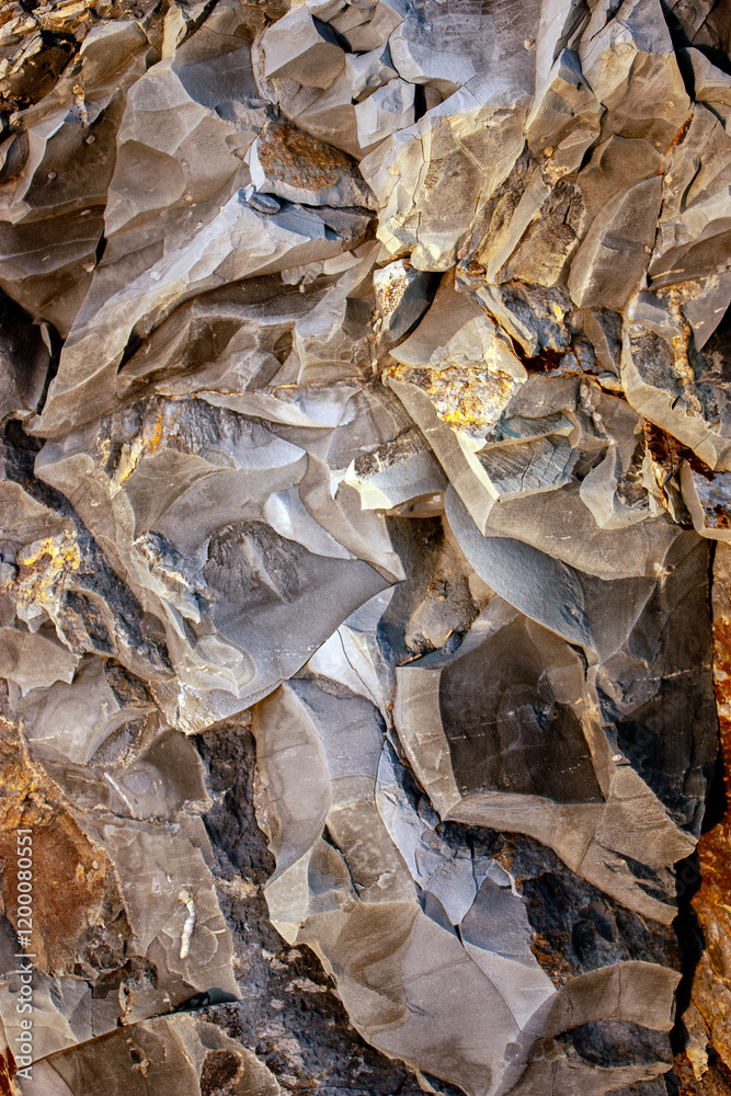 View of a part of a sedimentary rock. Yellow-brown abstract background. Texture of natural stone. Brown-yellow background for a banner. Rough drawing of a rock layer. View of a part of a sedimentary rock. Yellow-brown abstract background. Texture of natural stone. Brown-yellow background for a banner. Rough drawing of a rock layer.