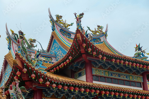 Intricate architecture of Chinese Thean Hou Temple. Roof is adorned with vibrant with dragon sculptures of mythical creatures. Rows of red lanterns hang above entrance. Kuala Lumpur, Malaysia, Asia photo