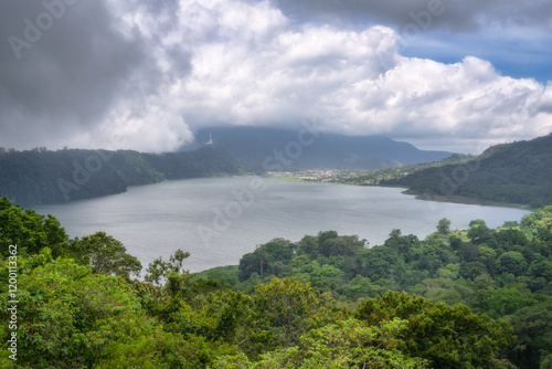 Obraz na płótnie A stunning landscape features a tranquil lake among lush hills, beneath a picturesque sky, perfect for nature lovers and outdoor enthusiasts seeking adventure, Bali, Indonesia w salonie