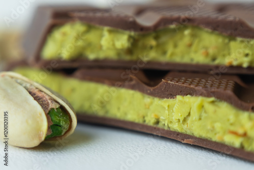 Photography The textured upper layer of Dubai chocolate and the fresh pistachio filling in a green color in macro detail