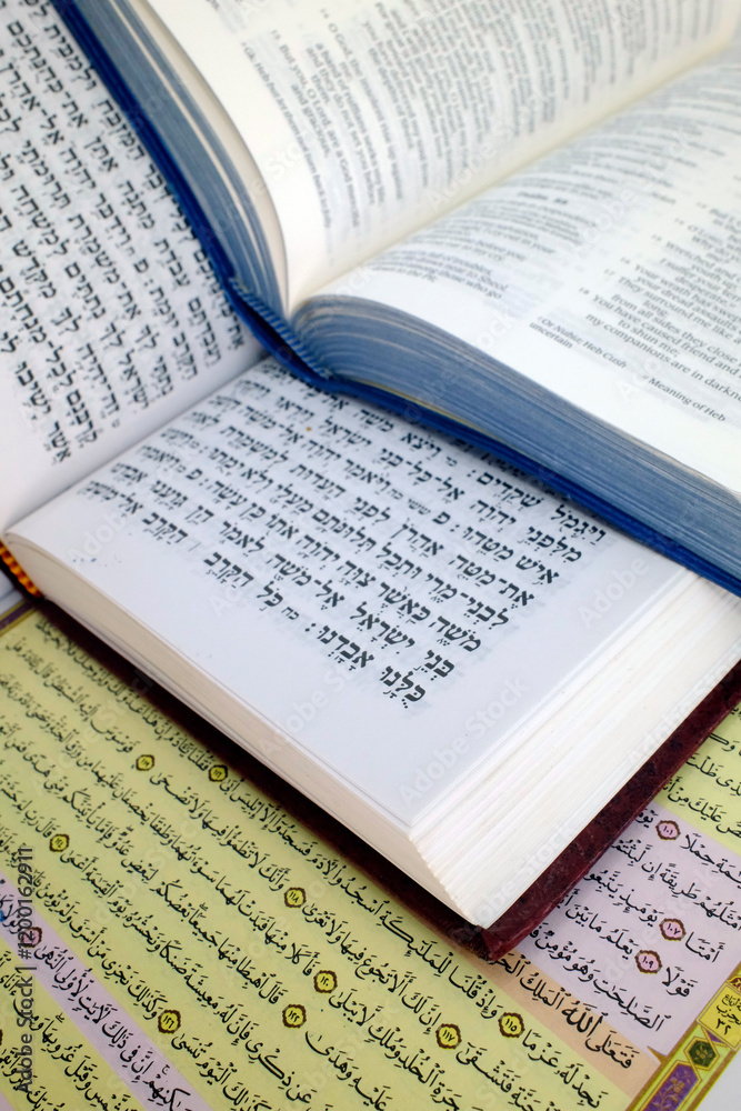 Obraz premium Quran, Bible, Talmud or Torah. Most significant religious texts revered by Judaism, Islam, and Christianity. Christianity, Islam and Judaism. Religious symbols. Faith and spirituality concept.