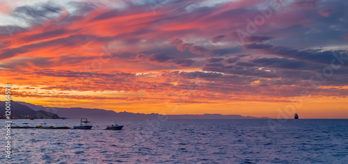 Summer sunset on a beach of the Red Sea where located famous tourist  resort ...