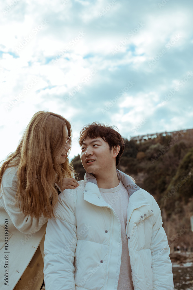 Young couple on the beach.
The woman stands behind the man leaning on his shoulders. Young couple on the beach.
The woman stands behind the man leaning on his shoulders.